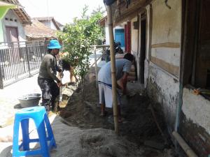 Satgas TMMD Bareng Warga Aduk Olahan Semen RTLH